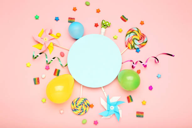 istock Colorful flat lay composition with various party items and candies on pink background 1189892359