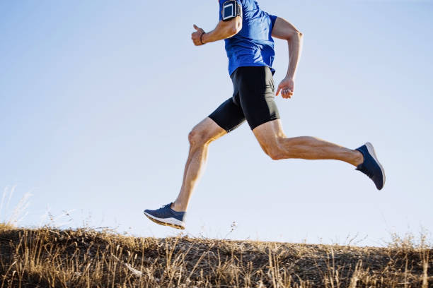 istock male runner running mountain trail 1189895758