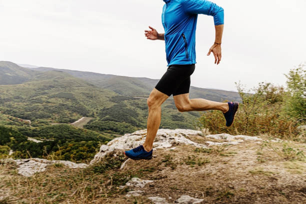 istock athletic man running mountain trail 1189895836