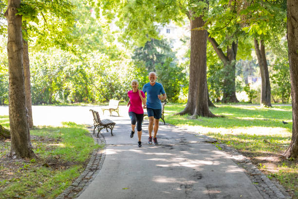 istock Mature Couple is Running in Public Park 1189896277