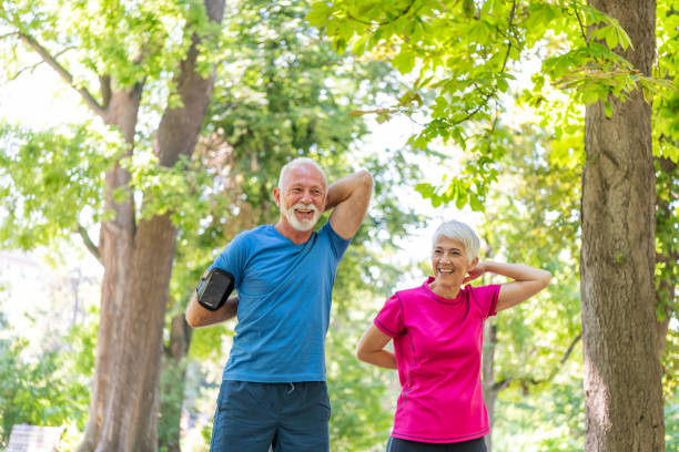 istock Active Senior Couple is Stretching Outdoors in Nature 1189897441