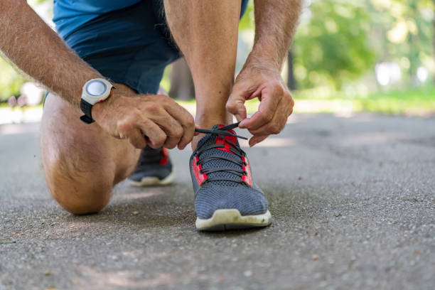 istock Senior Athlete Tying Sneaker Shoe 1189897889