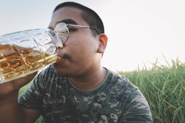 istock southeast asian man happily drinking beer 1189898029