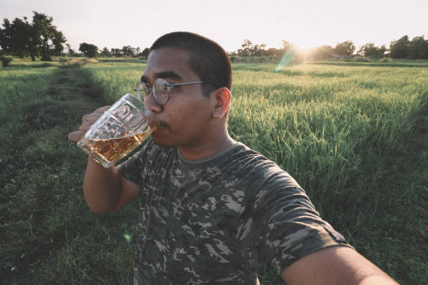 istock southeast asian man happily drinking beer 1189898053