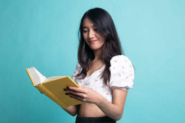 istock Young Asian woman read a book 1189901286