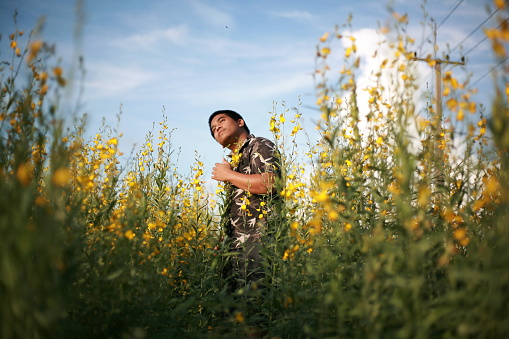 southeast asian man in flower field