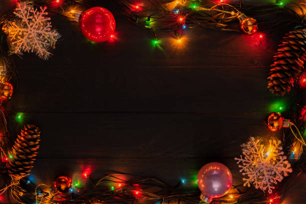 istock Christmas wooden board blue background garland toy tree cone top view frame 1189902925