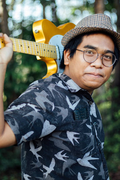 istock Brown skin man happily play his guitar 1189903601