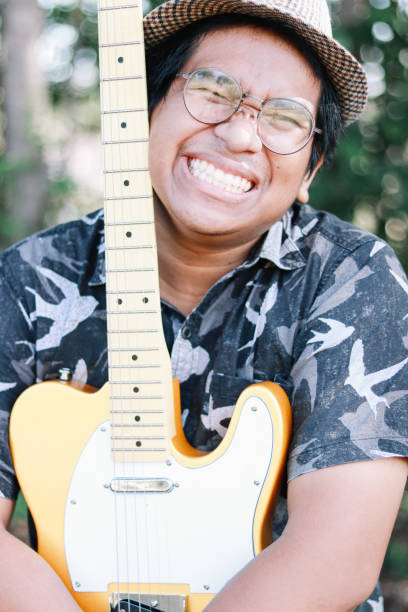 istock Brown skin man happily play his guitar 1189903779