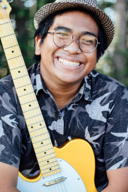 istock Brown skin man happily play his guitar 1189903801
