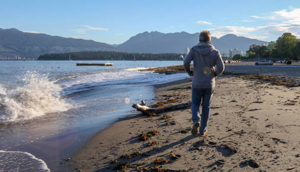istock Mature man walks along pier at sunrise 1189905014