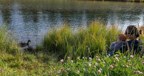 istock Mother and infant son at creek 1189905031