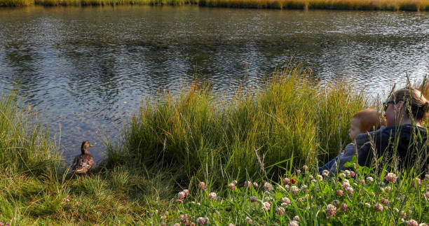 istock Mother and infant son at creek 1189905043