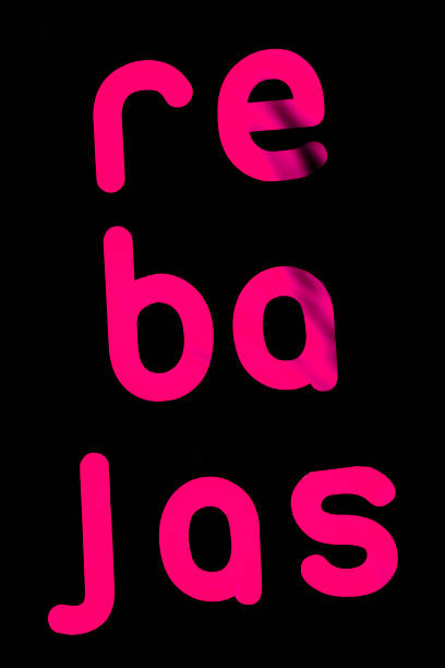 Sales sign in spanish language on a store window.
