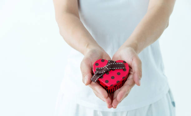 istock Woman hands holding a gift box on white background 1189907241