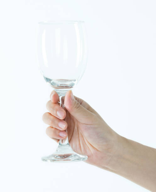 istock Woman hand holding empty wine glass 1189907243