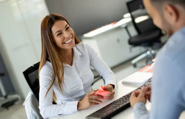 Photo of Beautiful woman manager communicates with the client in the work