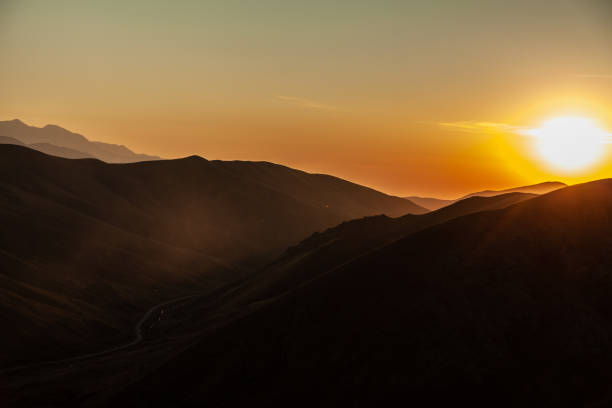istock mountains with road at the sunset 1189908617