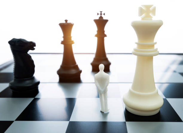 istock Man figurine standing on a chessboard 1189908778