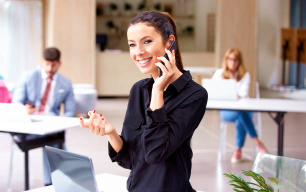 istock Attractive busienesswoman making a phone call while working in the office 1189908783