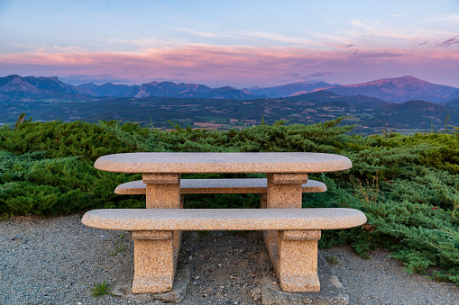 Idyllic rest place with stone bench and table and mountain view in Provence, France