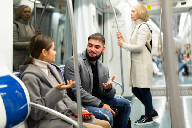 istock Guy enjoying conversation with woman in subway train 1189910564