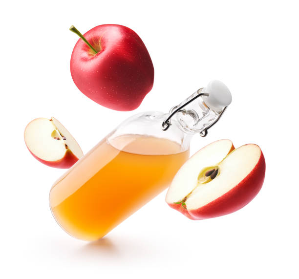 istock Apple cider vinegar with fresh red apples isolated on white background 1189910749