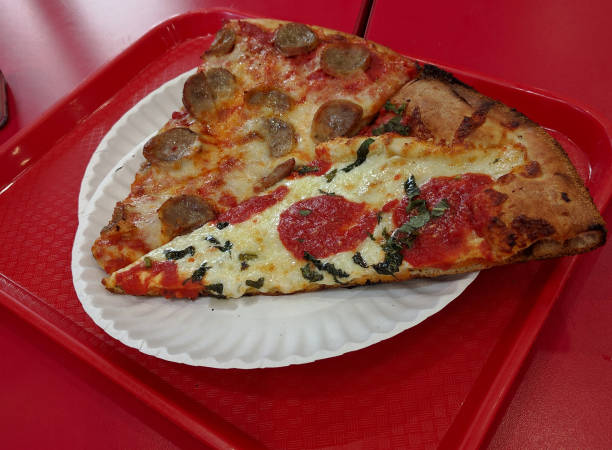 istock Generic slices of pizza on paper plate 1189912658