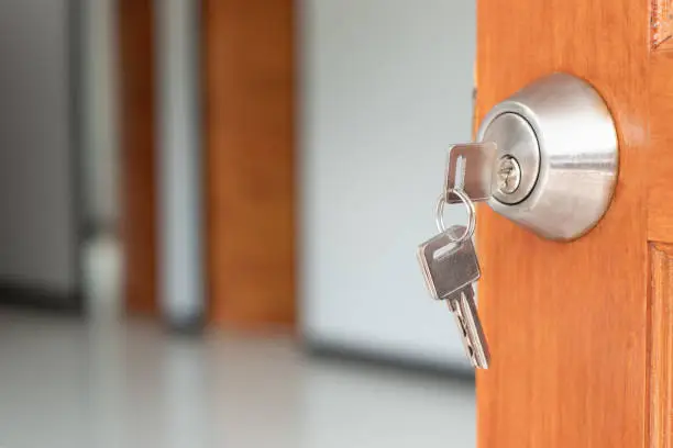 Key in keyhole on wood door,Opening a home door, Unlock door.