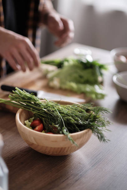 istock Man cutting green lettuce for salad 1189914791