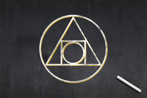 Blackboard with a the Philosopher's stone symbol used in alchemy drawn in the middle.