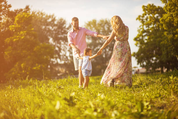istock Parents with daughter having fun in nature. 1189917016