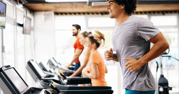 istock Group of friends exercising on treadmill machine 1189917199