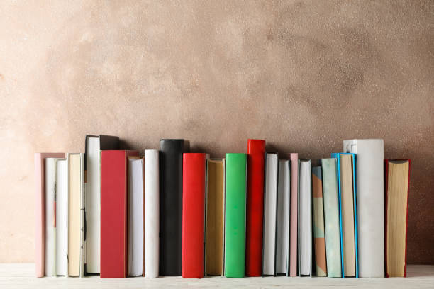 istock Books against brown background, space for text 1189917935