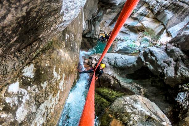 istock A high angle view of a canyoneer making a descent down a small waterfall in a canyon 1189919656