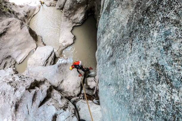 istock A high angle view of a canyoneer making a descent on a static rope down the canyon 1189919862