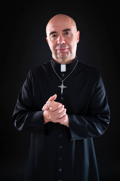 istock friendly priest honling hands portrait with cassock 1189921427