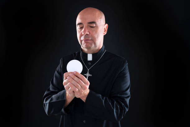 istock Priest holding communion wafer in eucharist 1189921445