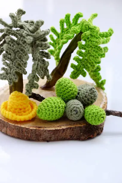Amazing Coconut tree with bunch of fruit in green yarn, ornament tree crochet product from leisure activity on white background