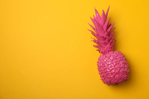 istock Painted pink pineapple on yellow background, space for text 1189922723