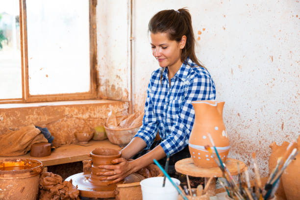 istock Female molding jug on pottery wheel 1189922753
