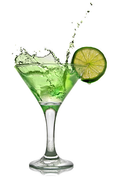 istock Green alchohol cocktail with lime and splash on white 118992350