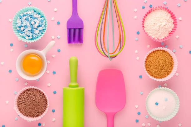istock baking ingredients, egg, flour, cocoa, sugar, sweet decoration and kitchen tools on pink background 1189924099