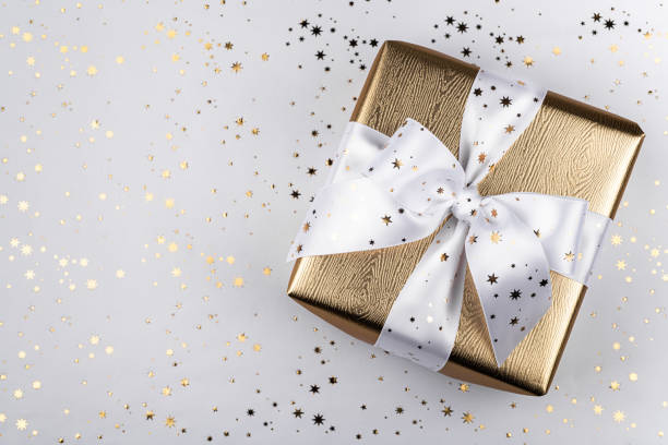 istock Gold gift box with a white ribbon. 1189924483