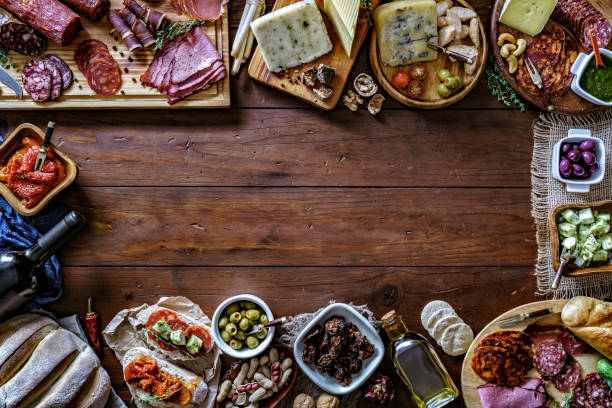 istock Tapas of cured ham and cheese delicious appetizer on rustic wood table with copy space 1189924604
