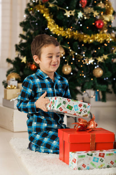 istock Cheerful boy with Christmas presents 1189924687
