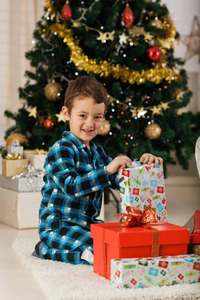 istock Cheerful boy with Christmas presents 1189924688