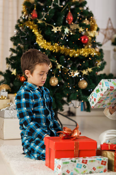 istock Cheerful boy with Christmas presents 1189924697