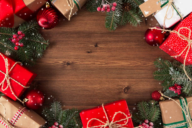 istock Christmas Gift Boxes on Brown Wooden Table 1189924798