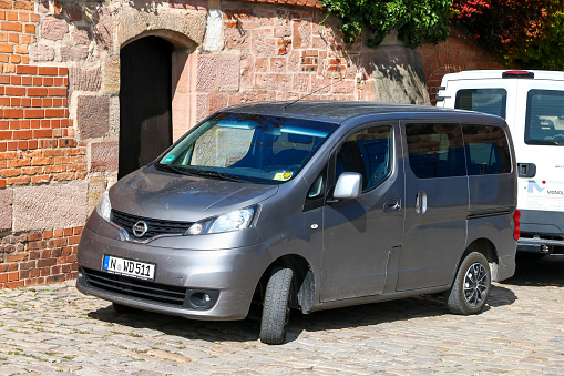 Nuremberg, Germany - September 19, 2019: Grey passenger van Nissan NV200 in the city street.